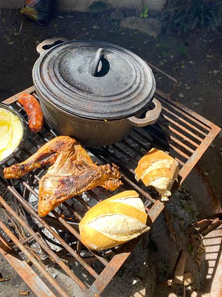 Cooking chicken and vegetables in a campsite with a cast iron pot