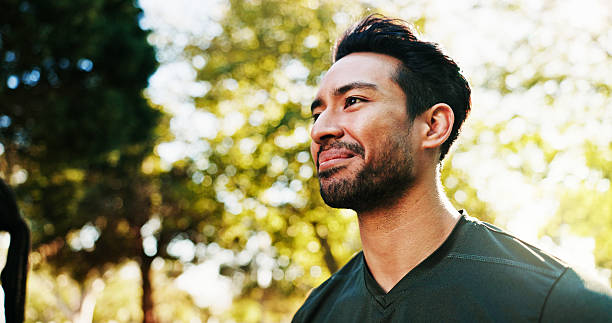 istock Man, smile and thinking with low angle in park, peace or calm with happy reflection, memory or future. Hope, mindfulness and male person pondering in nature, space and healthy mindset outdoor 2221672986