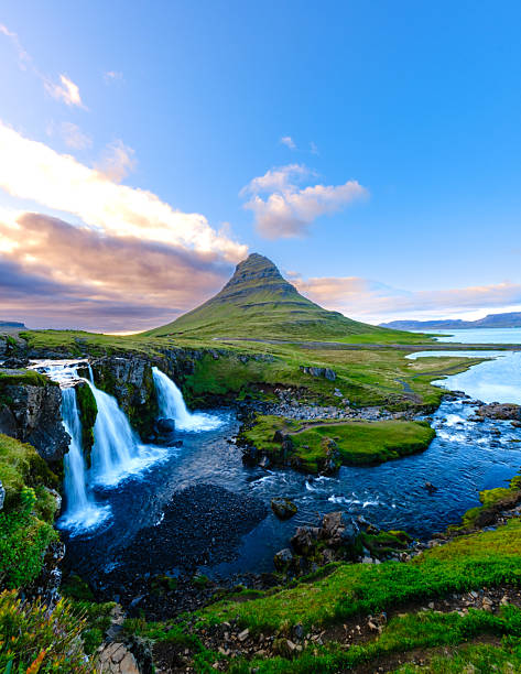 Majestic Kirkjufell mountain and waterfall under bright blue skies in Iceland