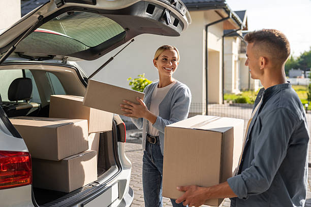 istock Young couple packing clothes into boxes and getting prepared for the moving in 2221675411