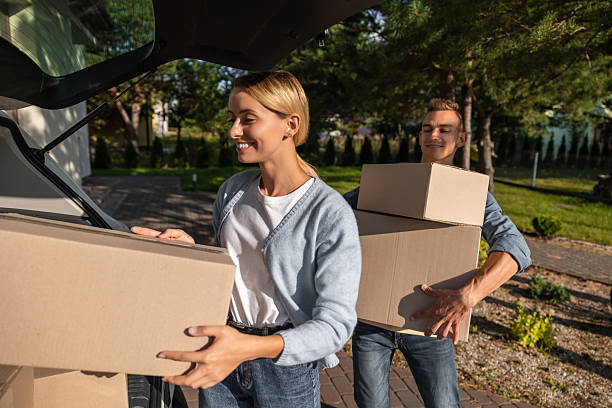 istock Young couple packing clothes into boxes and getting prepared for the moving in 2221675413