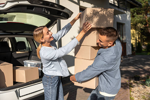 istock Young couple looking involved while preparing boxes for moving to a new house 2221675426