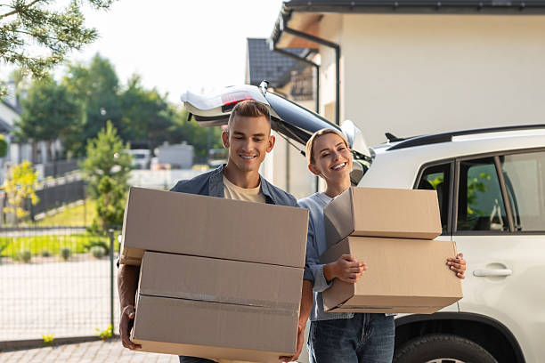istock Young couple looking involved while preparing boxes for moving to a new house 2221676172
