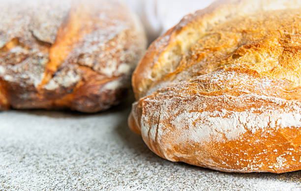 istock Freshly Baked Artisan Bread with Rustic Crust on Floured Surface 2221677250