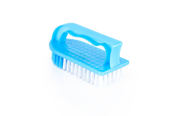 istock A vibrant blue scrub brush with white bristles, isolated on a white background. This cleaning tool is perfect for household chores and laundry. 2221677857