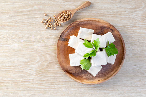 istock Fresh Sliced Soft Tofu soy bean curd on wood plate 2221681258