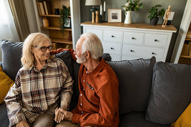 istock Senior couple relaxing on sofa at home. 2221681410