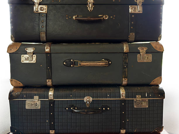 istock Stacked old big shabby hard shell suitcases made with leatherette 2221685243