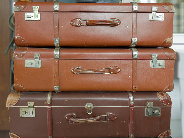 istock Stacked old big shabby hardshell suitcases made with leatherette 2221685745