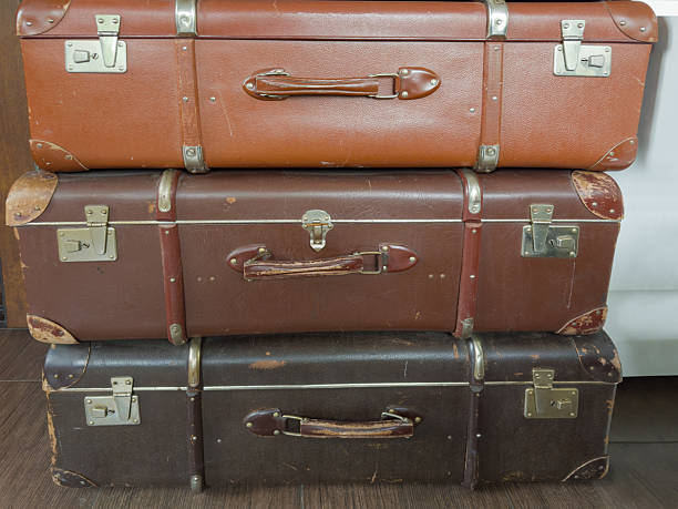 istock Stacked old shabby hardshell suitcases made with leatherette 2221685776