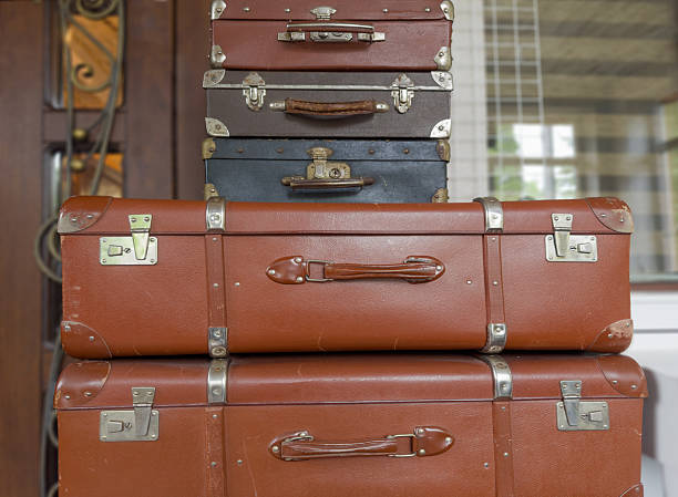 istock Stacked old shabby hardshell suitcases different sizes made with leatherette 2221685805