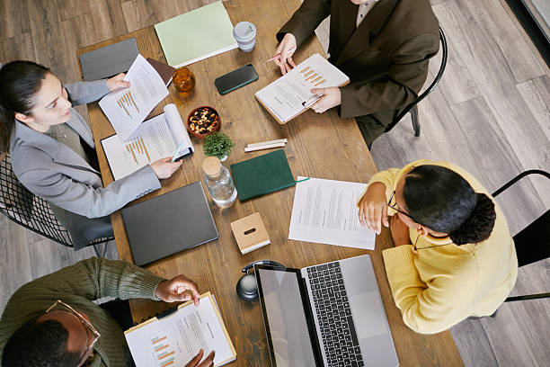 istock Diverse Young Adults Collaborating during Business Meeting at Office Table 2221688035