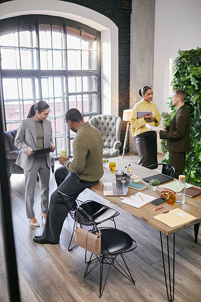 istock Multiethnic Young Adult Professionals Engaging in Informal Office Conversation 2221688041