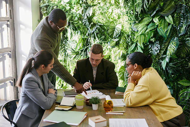 istock Middle Aged Black Man Guiding Multiethnic Team Analyzing Business Reports 2221688193