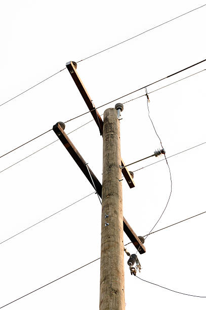 istock Telephone pole with electrical wires on a white sky 2221689507