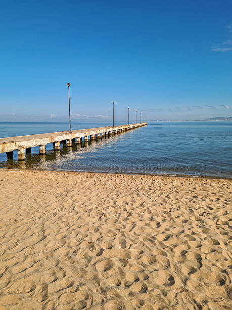 istock A Pier On The Sandy Beach In Greece 2221689961