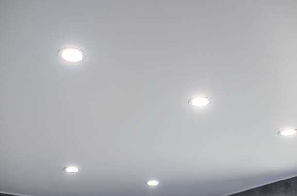 istock Ceiling with evenly spaced recessed lighting fixtures. 2221691018