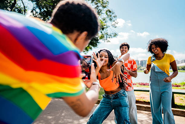 istock Young friends being filmed while dancing on public park 2221693101