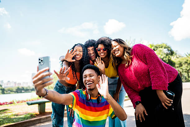 istock Friends talking on a video call using mobile phone on a public park 2221694191
