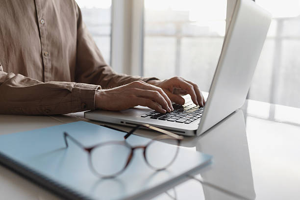 istock Man using laptop at home, businessman working in office 2221694406