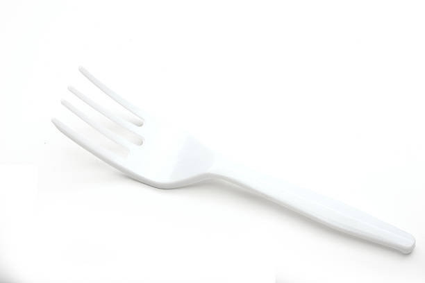 istock A single white plastic fork lies on a plain white background. The fork has three prongs and a smooth handle, suitable for casual dining or picnics. 2221695230