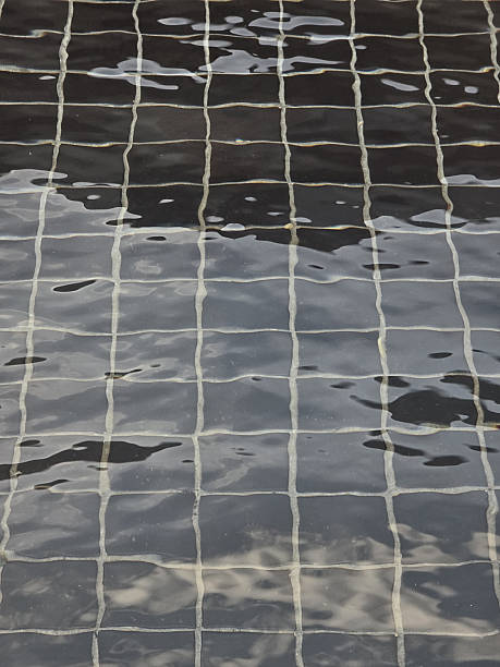 image shows textured surface of water with grid pattern reflecting light and creating serene atmosphere. interplay of light and shadow adds depth to scene