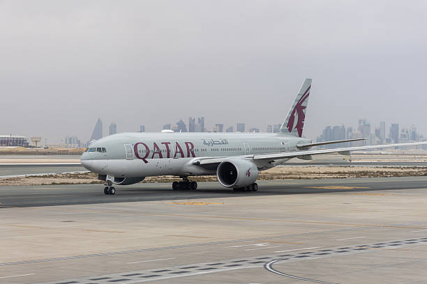 Doha, Qatar - February 24, 2025 : Qatar Airways Boeing 777-200 at Hamad International Airport in Doha, Qatar.