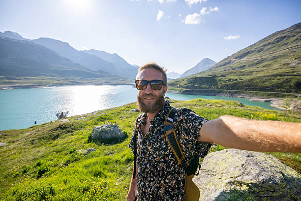 istock Man Taking Selfie by Scenic Mountain Lake 2221695719
