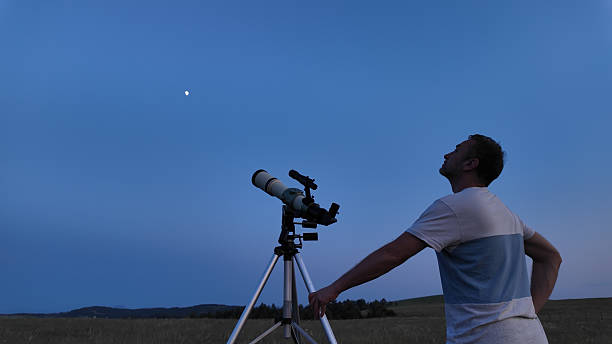 istock Amateur astronomer using telescope for watching stars, Moon, planets and other celestial objects from a field in nature. 2221696602