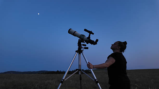 istock Amateur astronomer using telescope for watching stars, Moon, planets and other celestial objects from a field in nature. 2221696614
