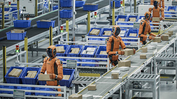 istock 3D Render: Multiple Autonomous AI-Enabled Humanoid Robots in a Row Work at Fulfillment Center. Automated Warehouse or Logistics Center with Advanced General Purpose Humanoid Robots 2221698901