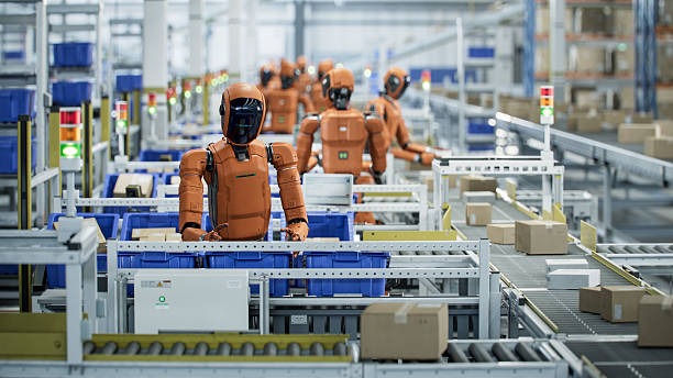 istock 3D Render: Autonomous AI-Enabled Humanoid Robot Working in Industrial Environment .He is Moving Boxes and Sorting Packages. Automated Warehouse or Fulfillment Center with Humanoid Robots. 2221698908