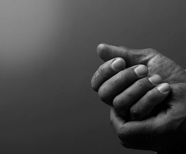 istock praying o God with hands together 2221700798