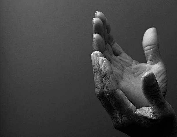 istock praying o God with hands together 2221700856