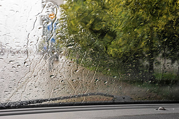 istock rain and tornado while driving on the road on the windshield. natural disaster 2221701651