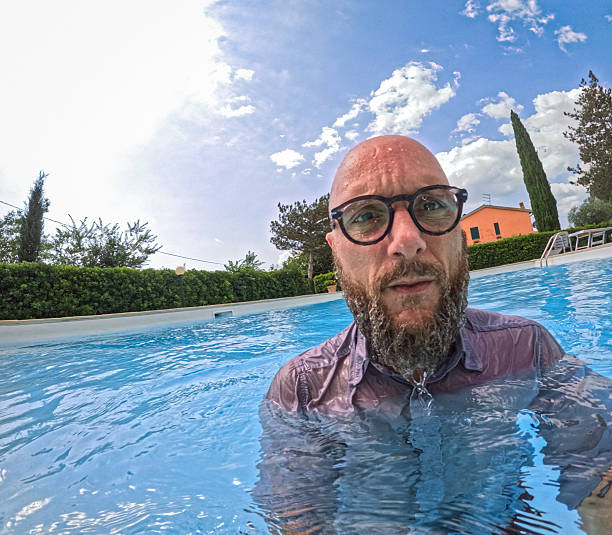 istock Man felt into the swimming pool dressed 2221702931