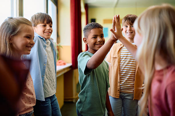 istock Happy kids greeting in the classroom at school. 2221704510