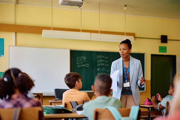 istock Black elementary school teacher talking to her students in the classroom. 2221704624