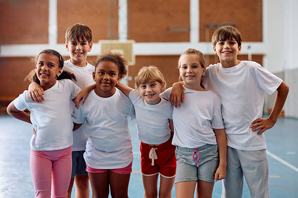 istock Multiracial group of school kids on PE class at school looking at camera. 2221704812