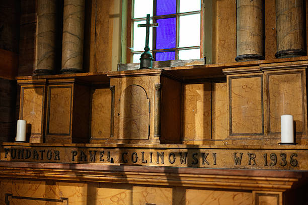 Lviv, Ukraine - June 21, 2025: Wooden altar in a historic church featuring a cross and intricate carvings.