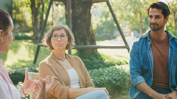 istock Diverse group people participating in outdoor community therapy session focused on mental health awareness and support sharing advice to promote empathy togetherness. Mental health concept. 2221707888