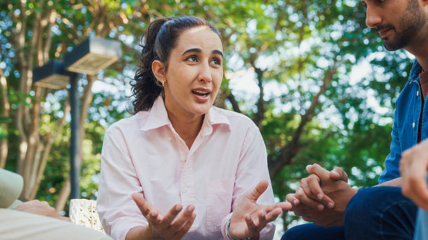 istock Diverse group people engaging in supportive group therapy session, sharing personal stories and advice to promote mental health and recovery in park. Mental health community concept. 2221707938
