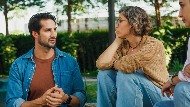 istock Diverse group people participating in outdoor community therapy session focused on mental health awareness and support sharing advice to promote empathy togetherness. Mental health concept. 2221707991