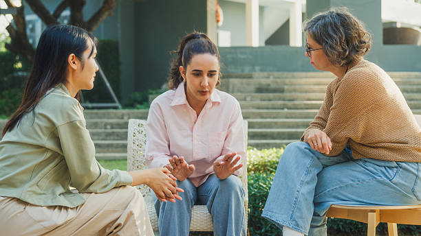 istock Diverse group people engaging in supportive group therapy session, sharing personal stories and advice to promote mental health and recovery in park. Mental health community concept. 2221708030