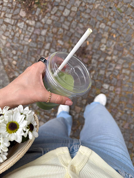 Influencer holding matcha latte and flowers