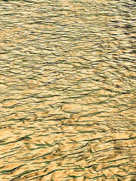 istock Golden Rippling Water Surface Under Natural Light. 2221710573