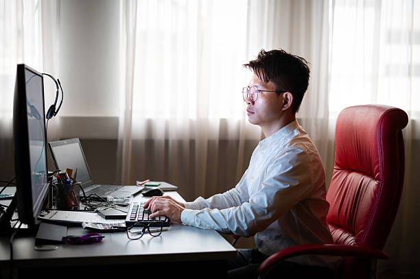 istock Mid aged businessman analyzes market trends with desktop PC at workstation 2221720268