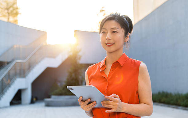 istock Businesswoman using digital tablet outside the office building 2221723980