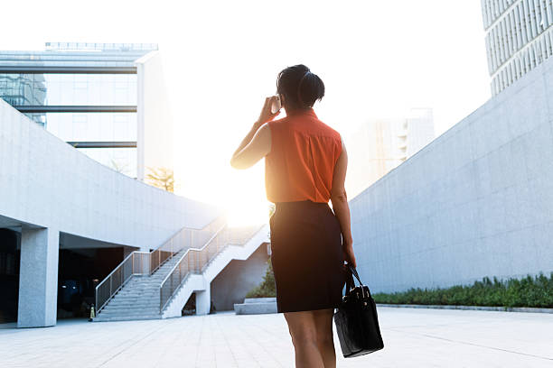 istock Businesswoman using smart phone outside the office building 2221723985