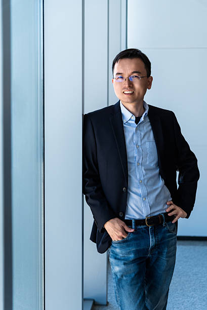 istock Businessman standing in office with hands in pockets 2221724183